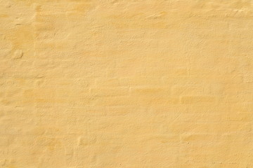 background of yellow brick wall  is covered plaster 