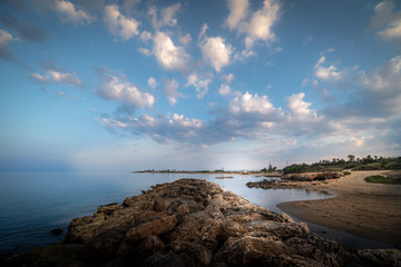 Naklejka premium Shot of the Cirica Bay at sunrise. Cirica is a beautiful nature seaside place made of cliffs, rocks and sand in the southern Sicily, Italy
