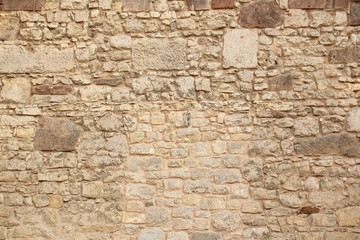 rough sandy texture of an old medieval stone wall. Background for design, close-up, copy space