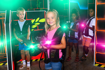 Girl with laser gun playing with friends