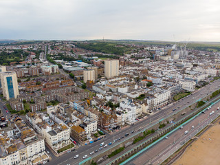 Fototapeta premium Aerial photo of the Brighton and Hove town centre showing hotels, guest houses, local businesses and the roads and streets of the town centre, taken on a bright sunny day with a drone over the town.