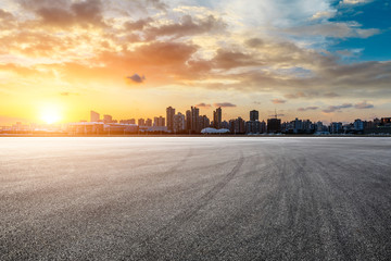 Asphalt race track and city skyline at sunset in Shanghai,China.