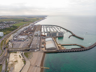 Aerial photo of the Brighton Marina and coastal area located in the south coast of England UK that is part of the City of Brighton and Hove, taken on a bright sunny day