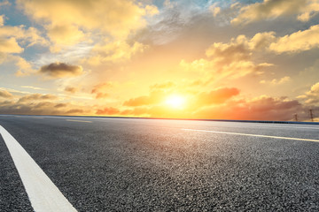 Empty asphalt highway and beautiful sky clouds at sunset