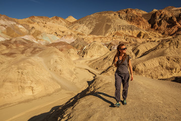 A hiker in the Artist`s Palette landmark place in Death Valley National Park, Geology, sand.