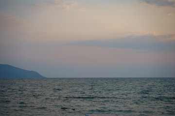 Sunset on the sandy beach with sea view. Seascape.