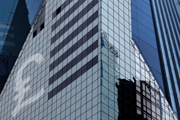 Modern office building with sign pound on a background of the bl