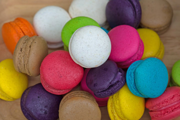 Fototapeta na wymiar Colorful Macaroons in dish on wooden table