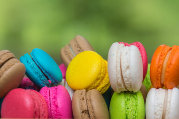 Colorful Macaroons in dish on wooden table