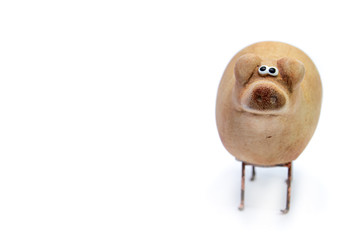Small clay figurines of pigs isolated on a white background. A symbol of prosperity and prosperity.