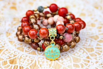 Lotus pendant mineral stone boho mala necklace on decorative background