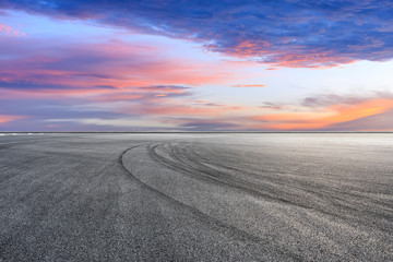 Empty race track road and beautiful sky clouds at sunset