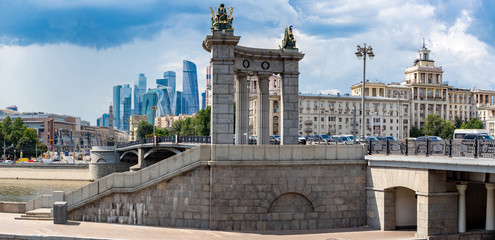 Fototapeta na wymiar Moscow. Russia. Panorama of the Borodino bridge. Moscow architecture of different eras. Summer embankment of Moscow river.Stone bridge in the capital.Sights of the capital of Russia.Russian Federation