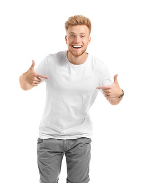 Man pointing at his t-shirt against white background
