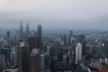 Naklejka na ściany i meble Aerial drone view of Kuala Lumpur city skyline during cloudy day