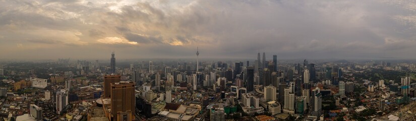 Aerial panorama of Kuala Lumpur city skyline during cloudy day