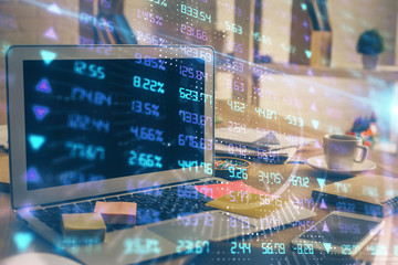 Double exposure of chart and financial info and work space with computer background. Concept of international online trading.