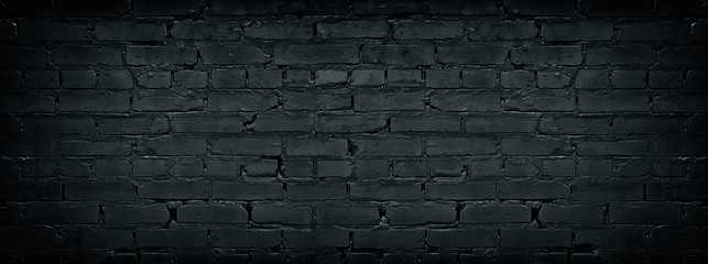 Wide black brick wall texture. Dark old masonry background. Rough brickwork