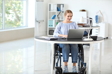 Handicapped young woman working in office