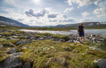 Naklejka premium person hiking at the river in the fjell, scenic landscape