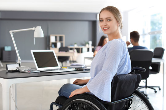Handicapped young woman working in office