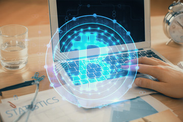 Blockchain theme hologram with man working on computer on background. Concept of crypto chain....