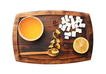 Cup of tasty tea with sugar and lemon on white background
