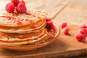 Plate with tasty pancakes and berries on table, closeup