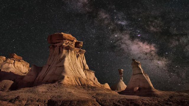 Cinemagraph of stars in motion over desert landscape at night