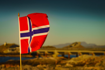 Naklejka premium Norwegian flag against Atlantic Road, Norway