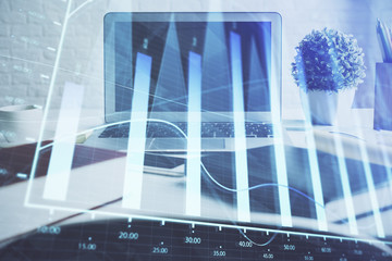 Forex graph hologram on table with computer background. Multi exposure. Concept of financial markets.