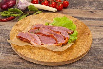 Sliced smoked duck breast served salad