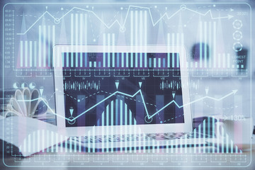 Financial market graph hologram and personal computer on background. Multi exposure. Concept of forex.