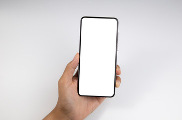 Hand holding the black smartphone with blank screen isolated on white background with clipping path.