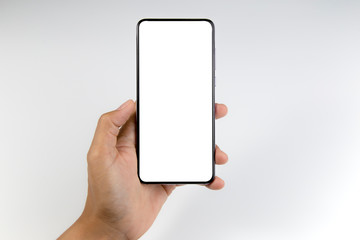 Hand holding the black smartphone with blank screen isolated on white background with clipping path.
