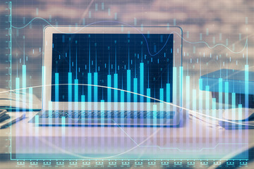 Stock market chart hologram drawn on personal computer background. Multi exposure. Concept of investment.