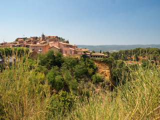 France, july 2019: Old Town of Roussillon, Provence, known as one of the most beautiful villages of France (Les Plus Beaux Villages de France), is situated by the ochre Red Cliffs (Les Ocres)