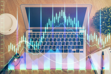 Multi exposure of graph and financial info and work space with computer background. Concept of international online trading.