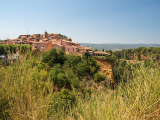 Fototapeta na wymiar France, july 2019: Old Town of Roussillon, Provence, known as one of the most beautiful villages of France (Les Plus Beaux Villages de France), is situated by the ochre Red Cliffs (Les Ocres)