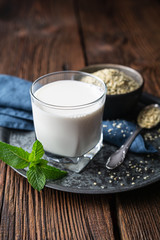 A bottle of freshly made dairy free hemp seed milk for vegans, decorated with mint