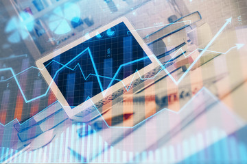 Forex market graph hologram and personal computer on background. Double exposure. Concept of investment.