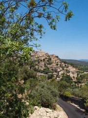 Fototapeta na wymiar France, july 2019: View of Gordes, a small medieval town in Provence. A view of the ledges of the roof of this beautiful village and landscape.