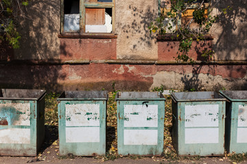 Old garbage containers in abandoned place
