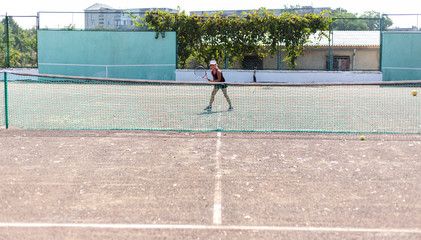 The child girl playing tennis