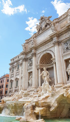 Rome trevi fountain and art statue (Fontana di Trevi) in Rome, Italy with bright day blue sky. Trevi is most famous fountain of Rome. Architecture and landmark of Rome. Postcard of Rome.