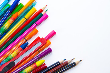 Felt-tip pens and pencils on a white background. Stationery layout. School theme. Preparing for school .Color school supplies isolated on white background. Study