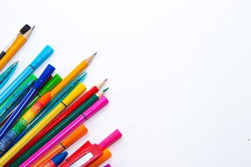 Felt-tip pens and pencils on a white background. Stationery layout. School theme. Preparing for school .Color school supplies isolated on white background. Study