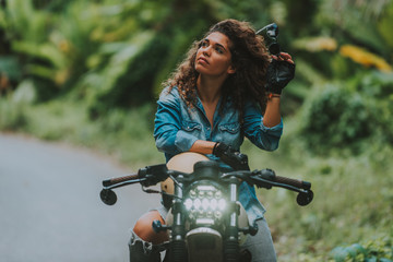 Fototapeta na wymiar Italian beautiful woman making a jungle tour with her motorcycle
