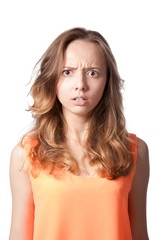 The girl is angry and frowned on a white background.