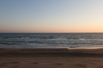 Beautiful sunset on a beach. Twilight on Tyrrhenian sea.